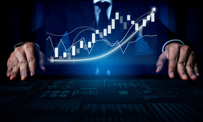A businessman analyzes financial data represented by stock market trends on a digital interface,...