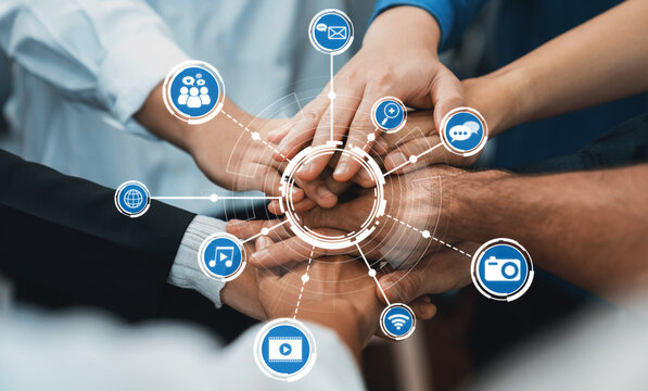 A close-up of diverse hands united in collaboration, surrounded by digital media icons that symbolize communication and connectivity in today interactive world. Amity