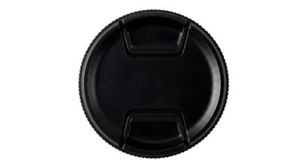 Black plastic texture shows camera lens cap detail against a dark backdrop. Suitable for product photography, presentations.
