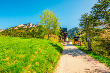 Peak Tri Koruny or Trzy Korony during day with green meadow and trees in spring. Pieniny National park in Slovakia and Poland