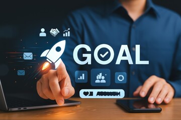 A person interacts with a holographic display of a rocket and the word "GOAL" overlaid with business icons.