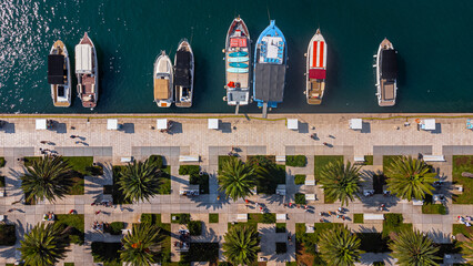 Abstract Top-down view of boats moored at the port of Split, Croatia. Aerial view in summer of boats in the water and the city's waterfront with trees