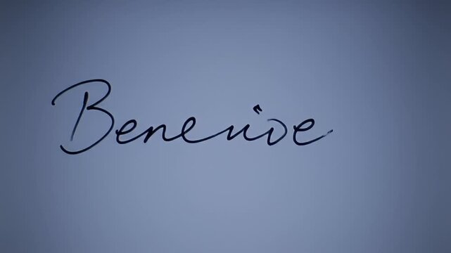 Hand writing 'Bene' on a white surface, arm is in silhouette