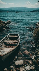 Obraz premium Small Boat by the Stony Shoreline