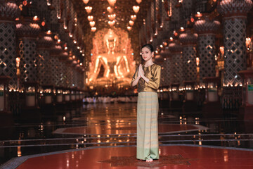 Elegant Woman in Traditional Outfit Standing in Serene Temple Interior