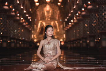 Elegant Woman in Traditional Attire Sitting in Serene Temple Atmosphere