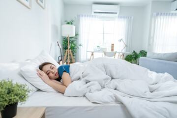 Asian beautiful woman lying down on bed in bedroom in morning at home. 