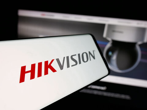 Stuttgart, Germany - 08-22-2025: Smartphone with logo of Hangzhou Hikvision Digital Technology on screen in front of website. Focus on center-left of phone display.