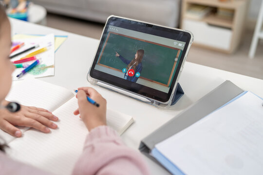 Close up of young student learning online class with teacher at home.  - Powered by Adobe