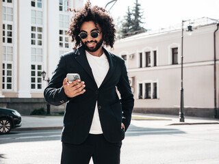 Handsome smiling hipster  model.Sexy unshaven Arabian man dressed in summer suit jacket...