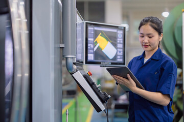 young technician engineer worker with CNC lathe metal machine in modern steel industry factory