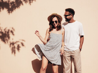 Smiling beautiful woman and her handsome boyfriend. Woman in casual summer clothes. Happy cheerful...
