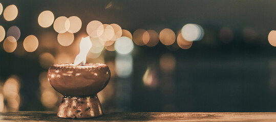 Soul and spirituality for death mourning abstract concept and world human spirit day with warm candlelight candle light  bokeh illumination, golden sunset sky and reflective river wave background