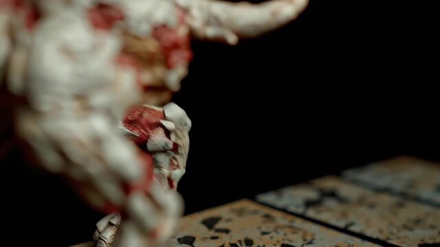 Zombie dog sculpture with cracked white and red textured skin and fierce yellow eyes snarling aggressively in dark background creating eerie creepy horror atmosphere perfect for horror themes