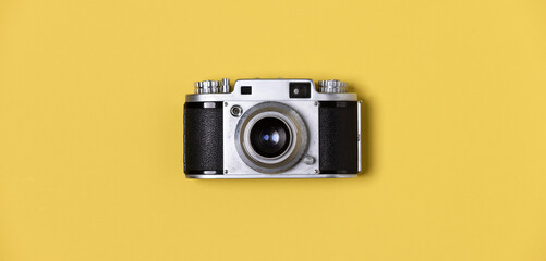 Flat lay, vintage film camera on pastel background, photography minimal idea.