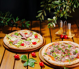 Delicious pizzas topped with fresh ingredients on a wooden table