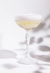 Elegant cocktail served in a delicate glass with a foamy top