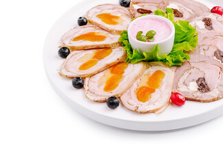 Delicious platter of assorted meats and sauces served on a white plate