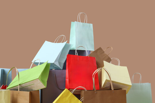 Heap of different shopping bags on brown background
