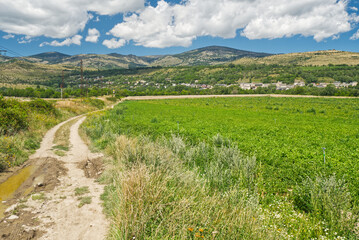Small Enveitg village with hills of Pyrenees mountains on the background near borders with Spain