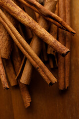 Cinnamon sticks dried tree bark spice on rustic wooden table background.