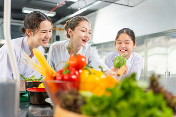 Culinary Instructor and Happy Students Working Together in a Kitchen, Chef Guiding Young Girls with Vegetables in a Cooking Class, Diverse Female Enjoying a Fun Cooking Session with Fresh Ingredients