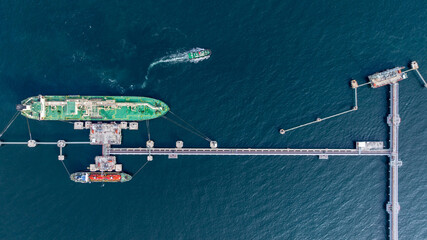 Aerial view oil ship tanker vessel loading and unloading in oil terminal station refinery, Global...