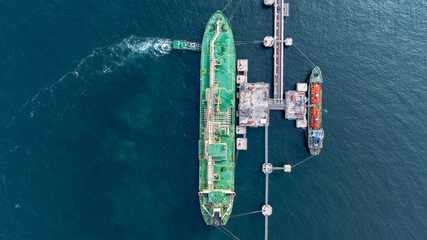 Aerial view oil ship tanker vessel loading and unloading in oil terminal station refinery, Global...