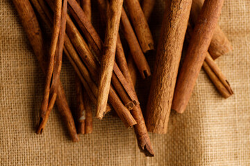 Cinnamon sticks dried tree bark spice on rustic background.