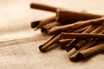 Cinnamon sticks dried tree bark spice on rustic background.
