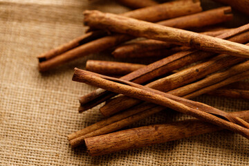 Cinnamon sticks dried tree bark spice on rustic background.
