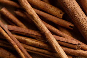 Cinnamon sticks dried tree bark spice on rustic background.