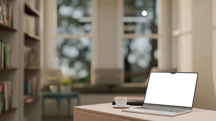 Modern workspace with laptop, coffee cup, and books on desk in bright living room