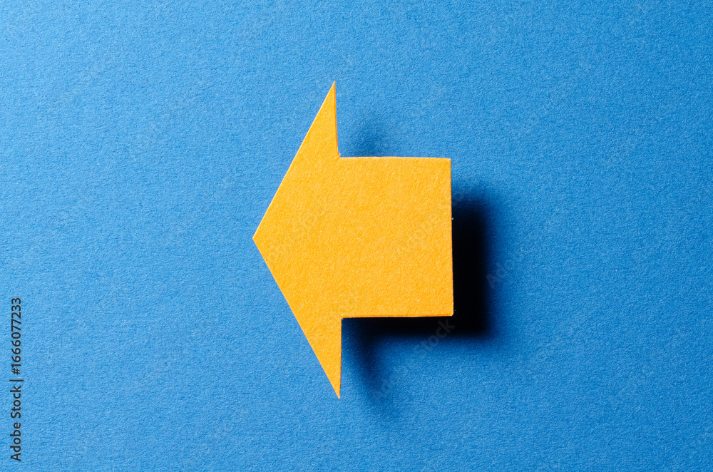 Poster orange blank paper cardboard arrow direction sign with shadow and copy space for text on blue backgr