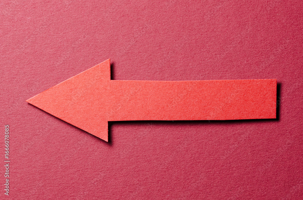 Poster cut out blank paper cardboard arrow direction sign with copy space for text on red background, flat 