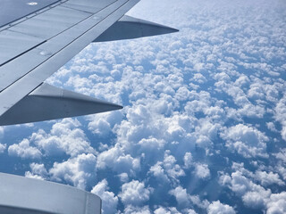 Beautiful cumulus clouds from the airplane window. Picturesque view from the airplane window at...