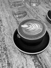 Flat White Coffee with Latte Art in Black and White. Meeting for Coffee at Cafe.	