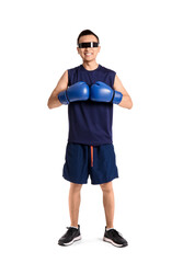 Sporty young Asian man in AR glasses with boxing gloves on white background