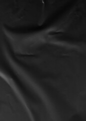 Fototapeta premium Black crumpled and creased glued paper isolated on a clean background. The textured surface adds depth and character, ideal for modern and artistic design projects. Hoja papel negro mojado.