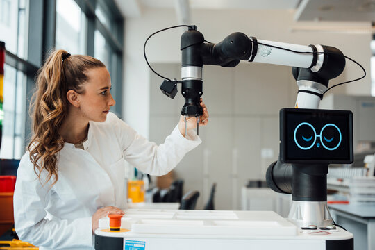 Scientist working with robot assistant in laboratory setting