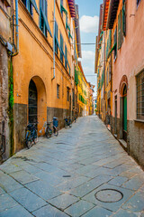 Narrow medeival street in old town of Lucca, Italy