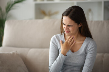Woman suffering throat ache complaining at home