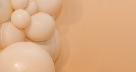 Minimal beige balloon decoration on soft background, elegant festive design for wedding, birthday,...