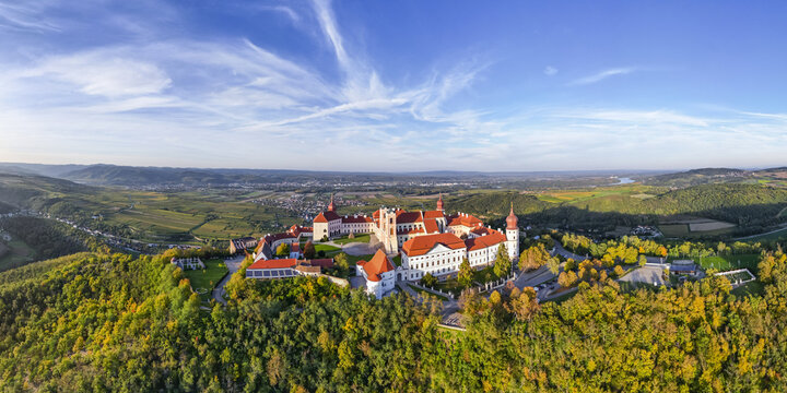 Aerial view of G&Atilde;&para;ttweig Abbey's white walls and red roofs contrast with the surrounding vibrant autumnal foliage, Furth bei G&Atilde;&para;ttweig, Nieder&Atilde;&para;sterreich, Austria.