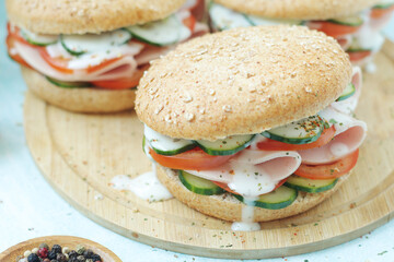Bun sandwiches with salami and vegetables	