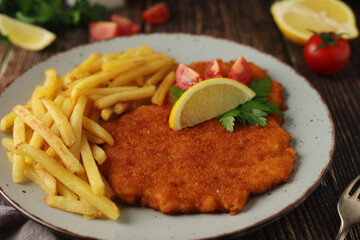 A Viennese schnizel with french fries	