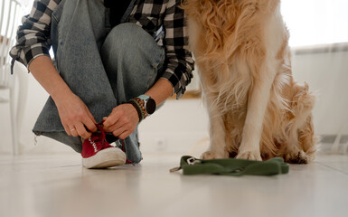 Girl Tying Shoelaces On Sneakers Before Walking With Dog