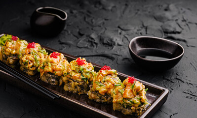 Sushi rolls with spicy mayo and roe served at a restaurant