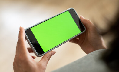 Girl Holding Smartphone With Green Chramakey Screen