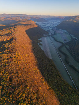 Aerial view of a valley bathed in the warm glow of the setting sun, casting long shadows across the landscape, Ple&Aring;&iexcl;ivec, Ko&Aring;&iexcl;ice Region, Slovakia.